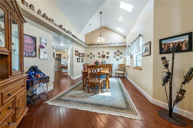 3640 E Vineyard Dr, Pahrump, NV 89048 - dining room with dark wood-style floors, baseboards, a skylight, and high vaulted ceiling