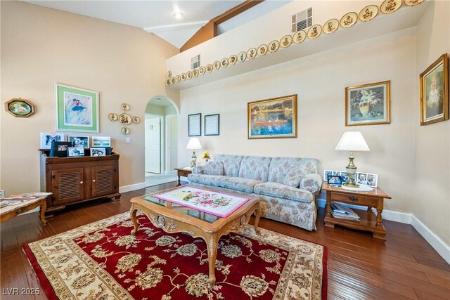 3640 E Vineyard Dr, Pahrump, NV 89048 - living area featuring arched walkways, hardwood / wood-style flooring, baseboards, and high vaulted ceiling
