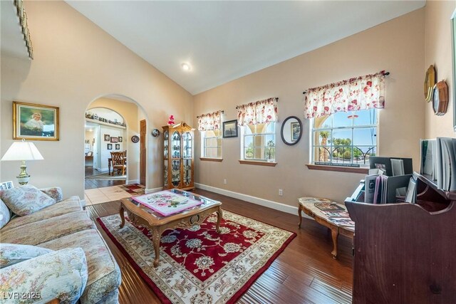 3640 E Vineyard Dr, Pahrump, NV 89048 - living area with arched walkways, vaulted ceiling, wood finished floors, and baseboards