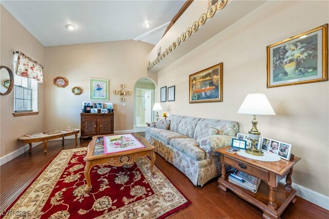 3640 E Vineyard Dr, Pahrump, NV 89048 - living area with arched walkways, lofted ceiling, baseboards, and wood finished floors