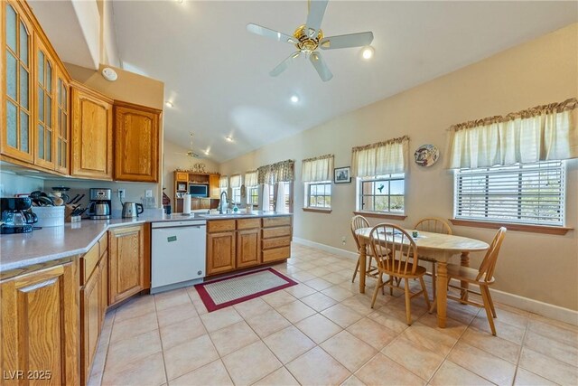 3640 E Vineyard Dr, Pahrump, NV 89048 - kitchen featuring white dishwasher, a peninsula, lofted ceiling, ceiling fan, and baseboards