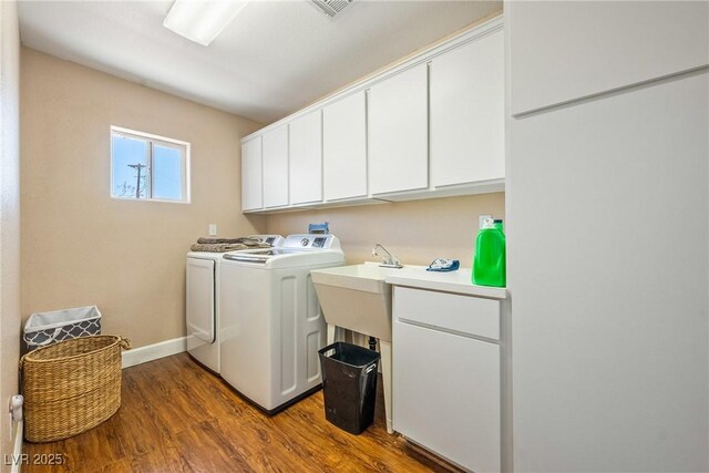 3640 E Vineyard Dr, Pahrump, NV 89048 - laundry area featuring cabinet space, washer and dryer, dark wood-style flooring, and baseboards