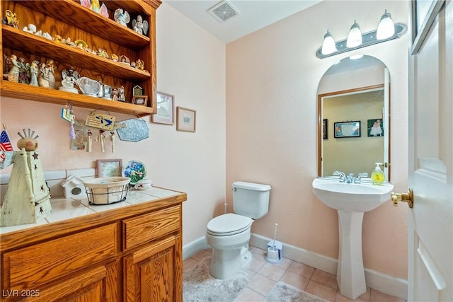 3640 E Vineyard Dr, Pahrump, NV 89048 - half bathroom with tile patterned flooring, toilet, and baseboards