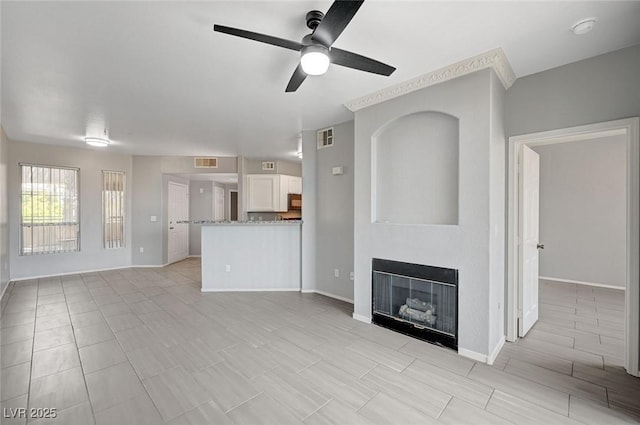 7189 S Durango Dr Unit 208, Las Vegas, NV 89113 - unfurnished living room with ceiling fan, a glass covered fireplace, and baseboards