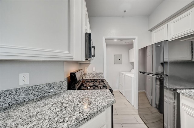7189 S Durango Dr Unit 208, Las Vegas, NV 89113 - kitchen featuring separate washer and dryer, electric panel, black appliances, white cabinetry, and light stone counters
