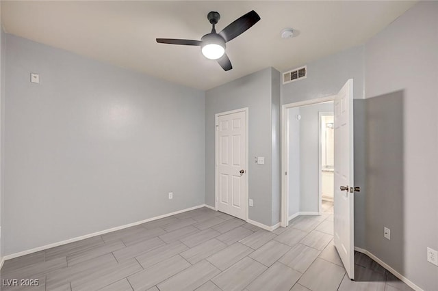 7189 S Durango Dr Unit 208, Las Vegas, NV 89113 - unfurnished bedroom with baseboards, wood tiled floors, and ceiling fan