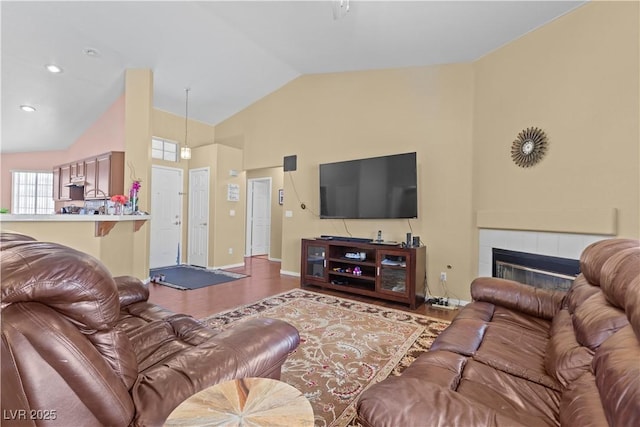 608 Blooming View Ave, North Las Vegas, NV 89032 - living room featuring wood finished floors, high vaulted ceiling, a fireplace, and baseboards