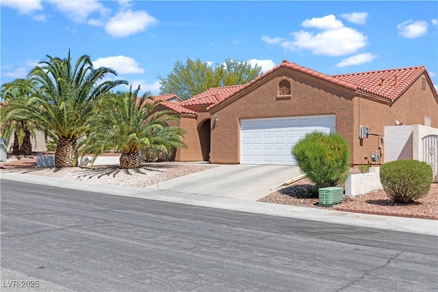 608 Blooming View Ave, North Las Vegas, NV 89032 - view of front of property featuring an attached garage, a tile roof, concrete driveway, and stucco siding