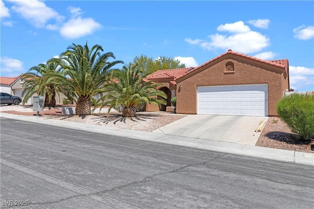 608 Blooming View Ave, North Las Vegas, NV 89032 - view of front facade with concrete driveway, a tile roof, a garage, and stucco siding