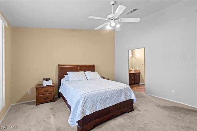 608 Blooming View Ave, North Las Vegas, NV 89032 - bedroom featuring light carpet, baseboards, a ceiling fan, and connected bathroom