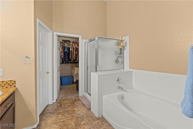608 Blooming View Ave, North Las Vegas, NV 89032 - bathroom featuring a shower stall, vanity, a bath, and a spacious closet