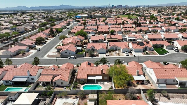 608 Blooming View Ave, North Las Vegas, NV 89032 - aerial perspective of suburban area featuring a pool and a mountainous background
