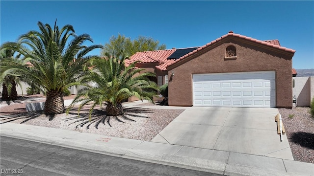 608 Blooming View Ave, North Las Vegas, NV 89032 - view of front facade featuring a tile roof, solar panels, stucco siding, driveway, and an attached garage