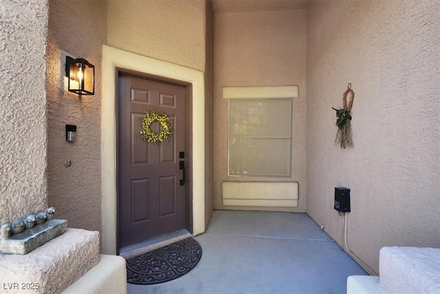 view of exterior entry with stucco siding