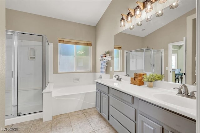 bathroom with a stall shower, a bath, double vanity, and tile patterned flooring