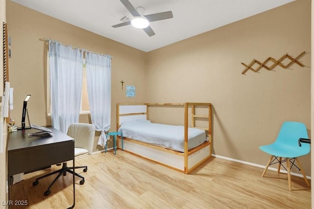 bedroom with wood finished floors, baseboards, and a desk