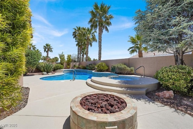 view of pool with a fenced backyard, an in-ground hot tub, and a patio area