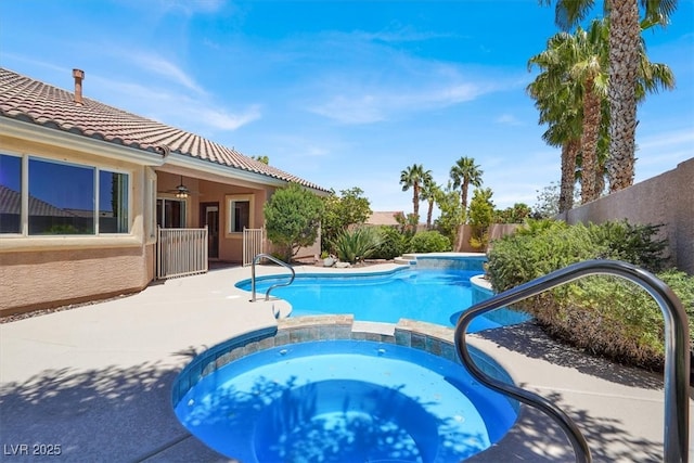 view of pool featuring ceiling fan, a pool with connected hot tub, a fenced backyard, and a patio area