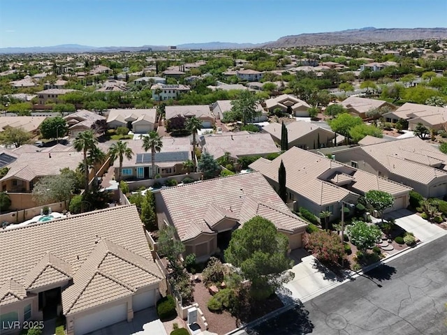 aerial view of residential area featuring a mountain backdrop