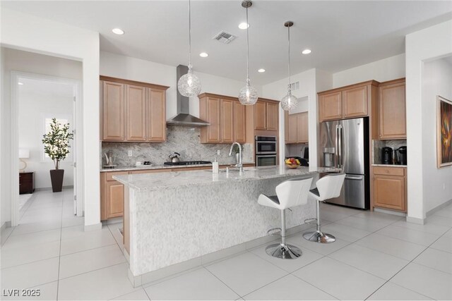 12844 New Providence St, Las Vegas, NV 89141 - kitchen featuring stainless steel appliances, wall chimney range hood, tasteful backsplash, a center island with sink, and a sink