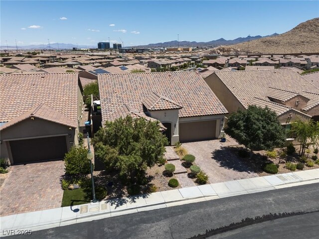 12844 New Providence St, Las Vegas, NV 89141 - view of front of home with a residential view, stucco siding, a mountain view, a tiled roof, and driveway