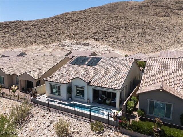 12844 New Providence St, Las Vegas, NV 89141 - back of house with a fenced backyard, stucco siding, a tiled roof, a mountain view, and a patio