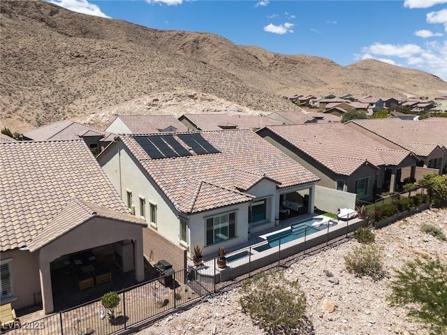 12844 New Providence St, Las Vegas, NV 89141 - rear view of property featuring stucco siding, solar panels, a fenced backyard, and a tiled roof