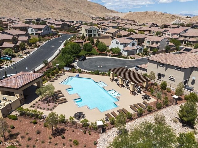 12844 New Providence St, Las Vegas, NV 89141 - aerial perspective of suburban area with a pool and mountains