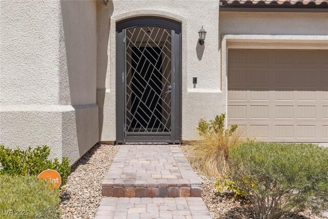 12844 New Providence St, Las Vegas, NV 89141 - view of exterior entry with stucco siding and a garage