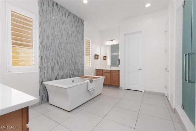 12844 New Providence St, Las Vegas, NV 89141 - full bathroom featuring vanity, a freestanding tub, wallpapered walls, recessed lighting, and tile patterned flooring