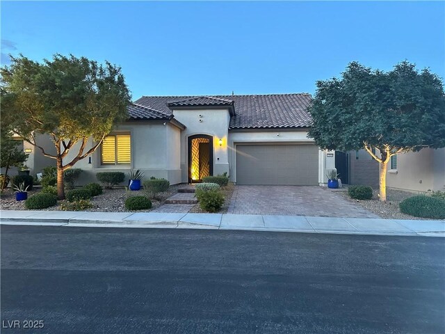 12844 New Providence St, Las Vegas, NV 89141 - mediterranean / spanish house featuring a tile roof, stucco siding, a garage, and driveway