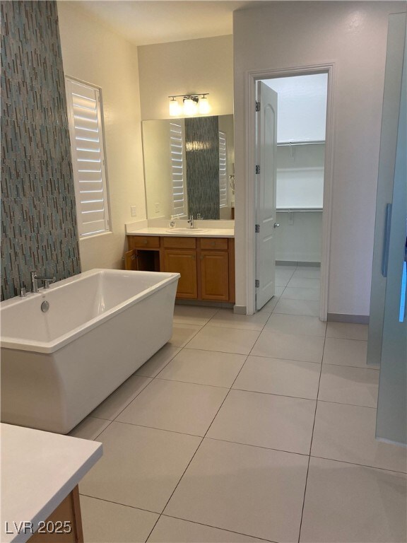 12844 New Providence St, Las Vegas, NV 89141 - bathroom with vanity, a soaking tub, and tile patterned floors
