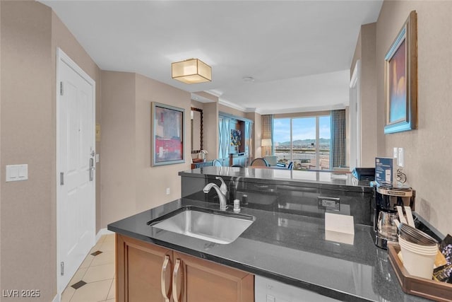 135 E Harmon Ave Unit 1102, Las Vegas, NV 89109 - kitchen with a sink, dark stone countertops, and light tile patterned floors