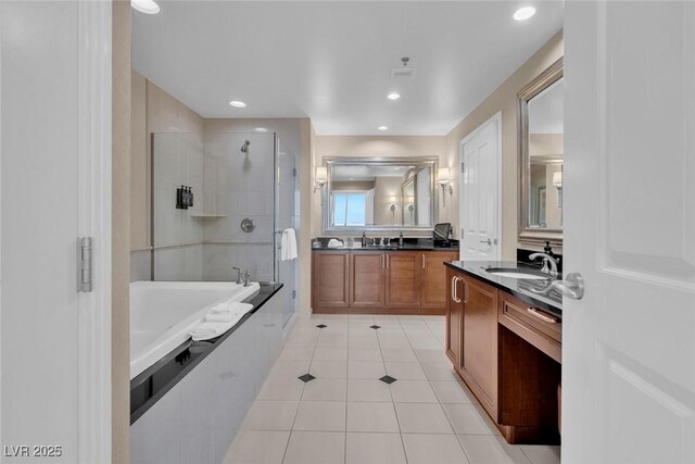 135 E Harmon Ave Unit 1102, Las Vegas, NV 89109 - full bath with a stall shower, tile patterned flooring, a garden tub, two vanities, and recessed lighting
