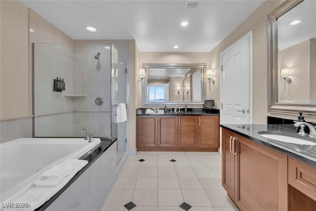 135 E Harmon Ave Unit 1102, Las Vegas, NV 89109 - full bathroom featuring a shower stall, tile patterned floors, a garden tub, two vanities, and recessed lighting
