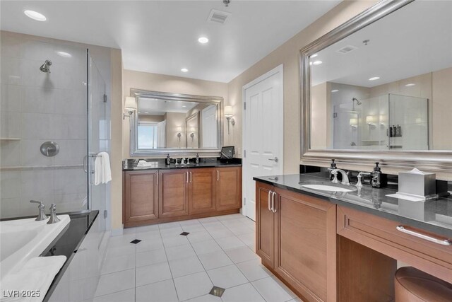 135 E Harmon Ave Unit 1102, Las Vegas, NV 89109 - full bathroom featuring a shower stall, tile patterned floors, two vanities, recessed lighting, and a bathtub