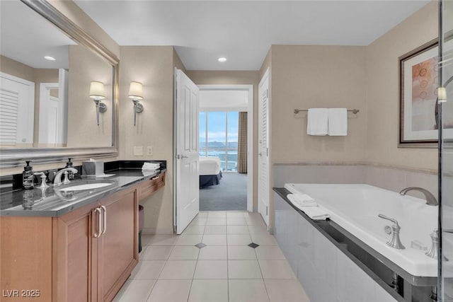 135 E Harmon Ave Unit 1102, Las Vegas, NV 89109 - bathroom with vanity, tile patterned floors, a bath, recessed lighting, and connected bathroom