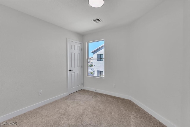 carpeted empty room with baseboards