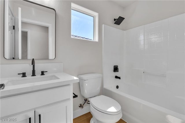 bathroom with toilet, vanity, and shower / washtub combination