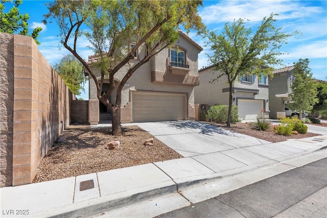 view of front of property featuring a garage, driveway, stucco siding, and fence