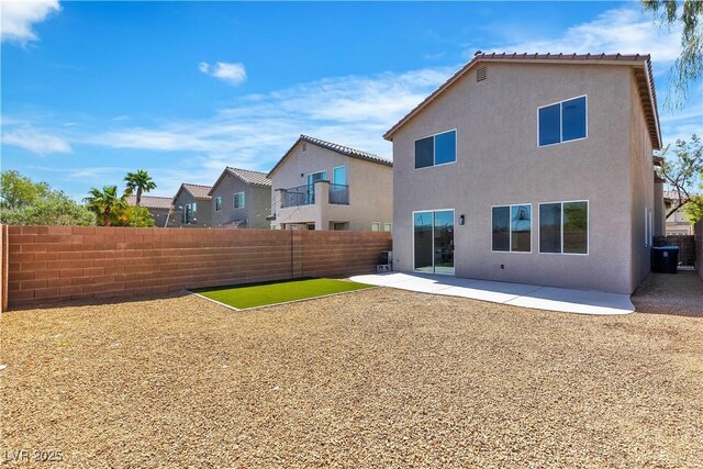 back of property featuring a fenced backyard, stucco siding, and a patio area