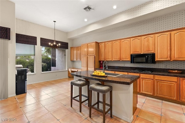 4649 Bird View Ct, Las Vegas, NV 89129 - kitchen with wallpapered walls, black microwave, a sink, a chandelier, and gas stovetop