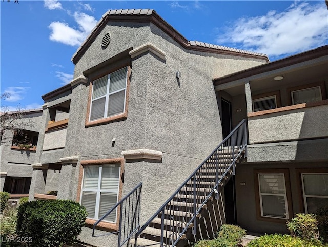 555 E Silverado Ranch Blvd Unit 2147, Las Vegas, NV 89183 - view of side of property featuring stucco siding and stairs