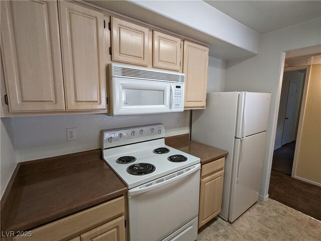 555 E Silverado Ranch Blvd Unit 2147, Las Vegas, NV 89183 - kitchen with white appliances, dark countertops, and light brown cabinets
