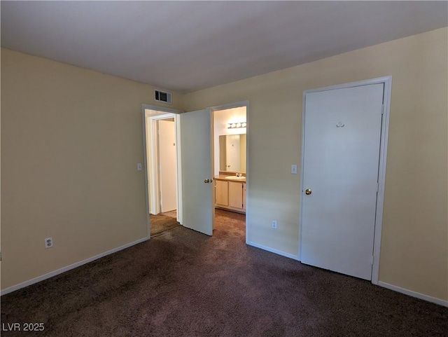 555 E Silverado Ranch Blvd Unit 2147, Las Vegas, NV 89183 - unfurnished bedroom featuring dark carpet, baseboards, and ensuite bath