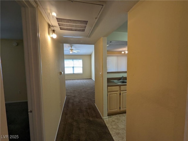 555 E Silverado Ranch Blvd Unit 2147, Las Vegas, NV 89183 - hall with attic access, light colored carpet, a sink, and baseboards