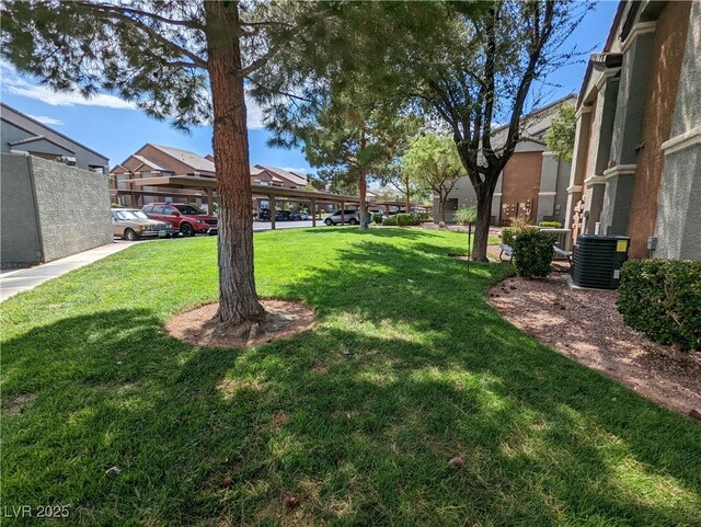 555 E Silverado Ranch Blvd Unit 2147, Las Vegas, NV 89183 - view of grassy yard with central air condition unit and a residential view