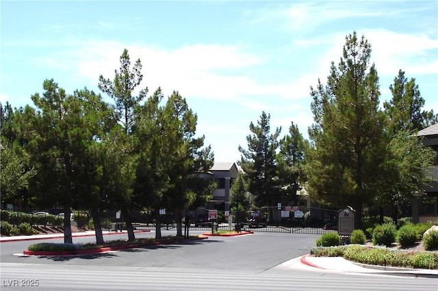 555 E Silverado Ranch Blvd Unit 2147, Las Vegas, NV 89183 - view of asphalt road with curbs, a gated entry, a gate, and sidewalks