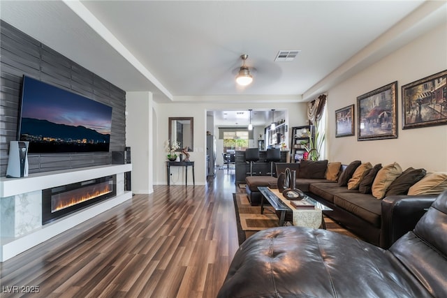 184 Cullerton St, Las Vegas, NV 89148 - living area featuring wood finished floors, a large fireplace, a raised ceiling, and baseboards