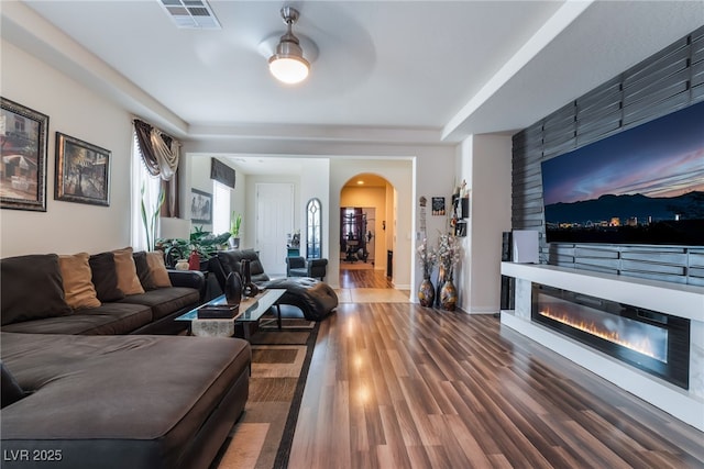184 Cullerton St, Las Vegas, NV 89148 - living room with wood finished floors, arched walkways, and a glass covered fireplace